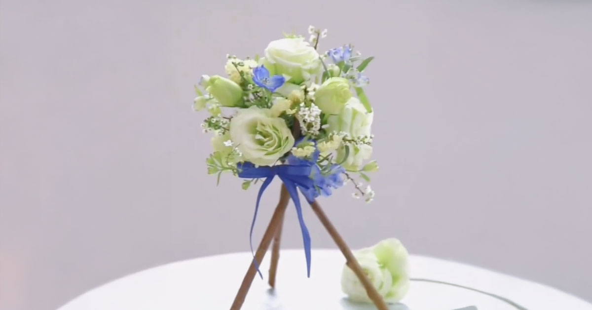 Pastel colored flower arrangement with purple bow. Perfect for Valentine's Day